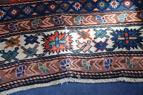 A Caucasian red ground rug, 6ft 10in by 5ft 3in
